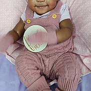 Paisley joined the competition — help win amazing prizes! baby, infant, child, portrait, smiling, sitting, pink_outfit, headband, bow, overalls, blanket, pillow, bed, milestone_card, indoor, close_up, face, happy, fashion, cozy