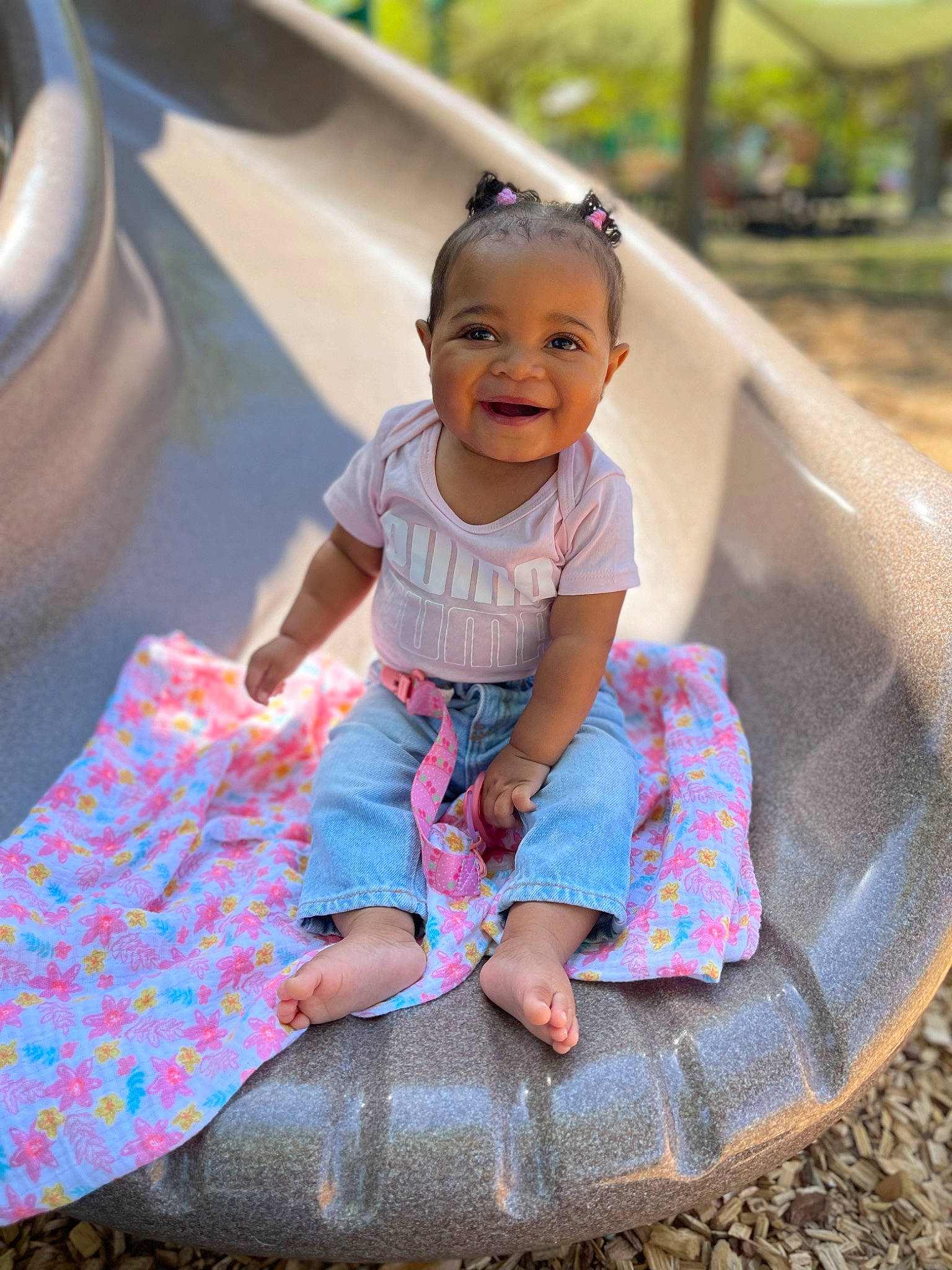 Rio is registered to the contest to win money with this photo: baby_toddler_clothing, child, face, fun, grass, hairstyle, happy, joy, leisure, magenta, pattern, person, pink, product, public_space, recreation, shorts, sleeve, smile, summer