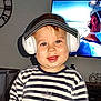 toddler, child, headphones, striped_shirt, smile, indoor, living_room, clock, television, face, cute, happy, person, baby, chubby_cheeks, short_hair, technology, casual_clothing, home, portrait