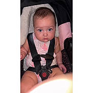 Sofia is registered to the contest to win money with this photo: baby, child, car_seat, seatbelt, straps, pink_outfit, cushion, infant, wide_eyes, chubby_cheeks, sitting, indoors, person, cute, secure, looking_at_camera, close_up, soft_lighting, young_child, portrait
