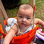 baby, child, swing, orange, blanket, outdoor, grass, curious, face, infant, person, closeup, portrait, seat, playground, cute, expression, summer, soft_focus, baby_clothes