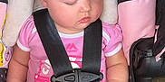 Sofia is registered to the contest to win money with this photo: baby, sleeping, car_seat, child, infant, pink_shirt, seatbelt, safety_harness, cute, peaceful, portrait, child_safety, resting, indoors, person, young_child, toddler, seat, clothing, baby_carrier