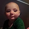 Jupiter is registered to the contest to win money with this photo: baby, cheeks, child, cute, dim_light, expression, eyes, face, green_shirt, head, indoor, long_eyelashes, mouth, nose, person, portrait, skin, star_filter, toddler, young_child