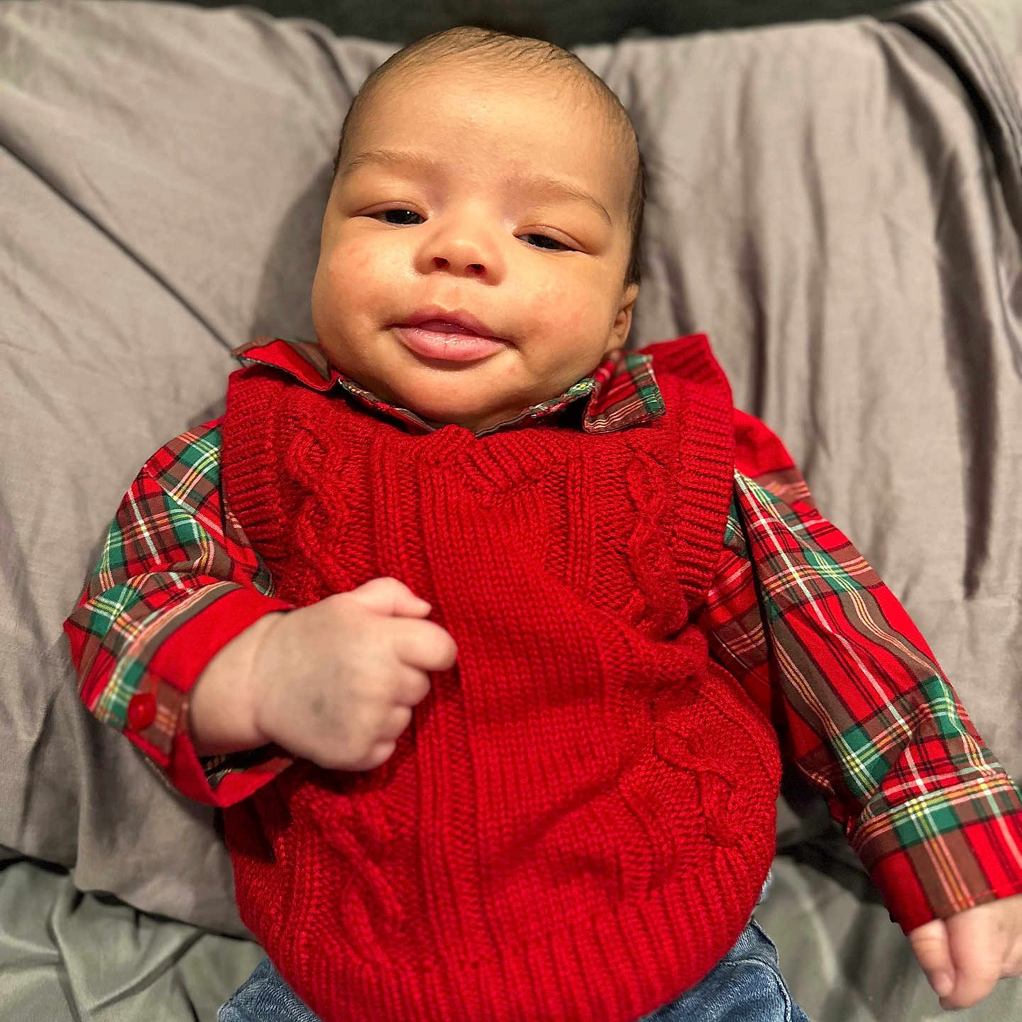 Kameron is registered to the contest to win money with this photo: baby, blanket, clothing, couch, cushion, face, furniture, happy, head, homedecor, jeans, knitwear, pants, person, photography, portrait, sitting, sleeve, smile, sweater