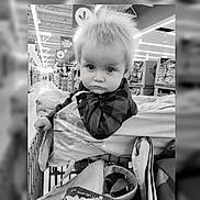 Ben joined the competition — help win amazing prizes! child, toddler, baby, portrait, face, serious, looking_at_camera, shopping_cart, supermarket, grocery_store, indoors, store_aisle, blanket, clothing, plaid, cart, black_and_white, sitting, retail, photograph