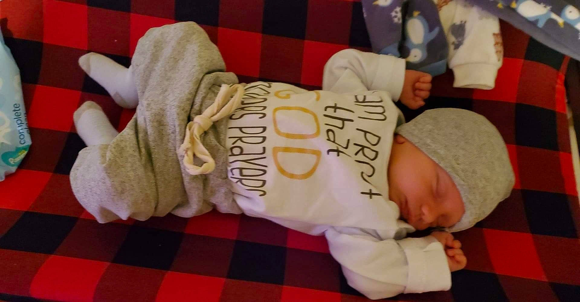 Harlan is registered to the contest to win money with this photo: baby, baby_products, baby_sleeping, baby_toddler_clothing, beanie, bedtime, comfort, headwear, knit_cap, linens, nap, person, plaid, sleep, textile