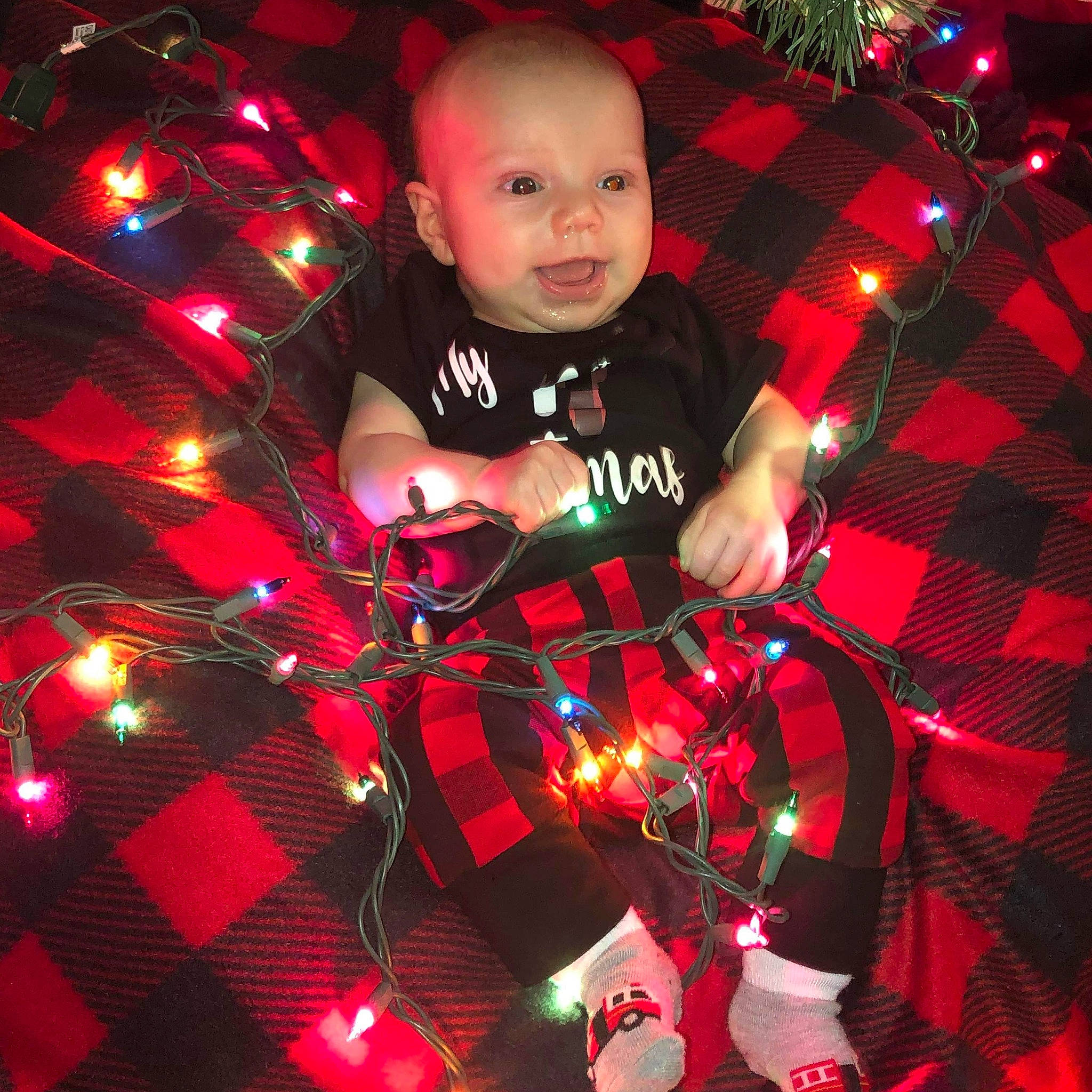 Harlan joined the competition — help win amazing prizes! baby, baby_toddler_clothing, carmine, christmas, christmas_decoration, christmas_eve, christmas_lights, christmas_ornament, holiday, light, ornament, pattern, person, plaid, red, textile