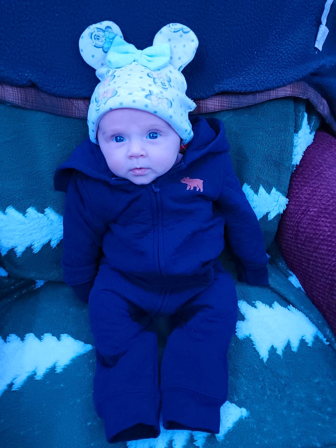 Astrid is registered to the contest to win money with this photo: baby, baby_toddler_clothing, beanie, blue, costume_hat, electric_blue, eye, fashion_accessory, flash_photography, freezing, fun, grass, happy, head, headwear, magenta, person, plant, purple, toddler