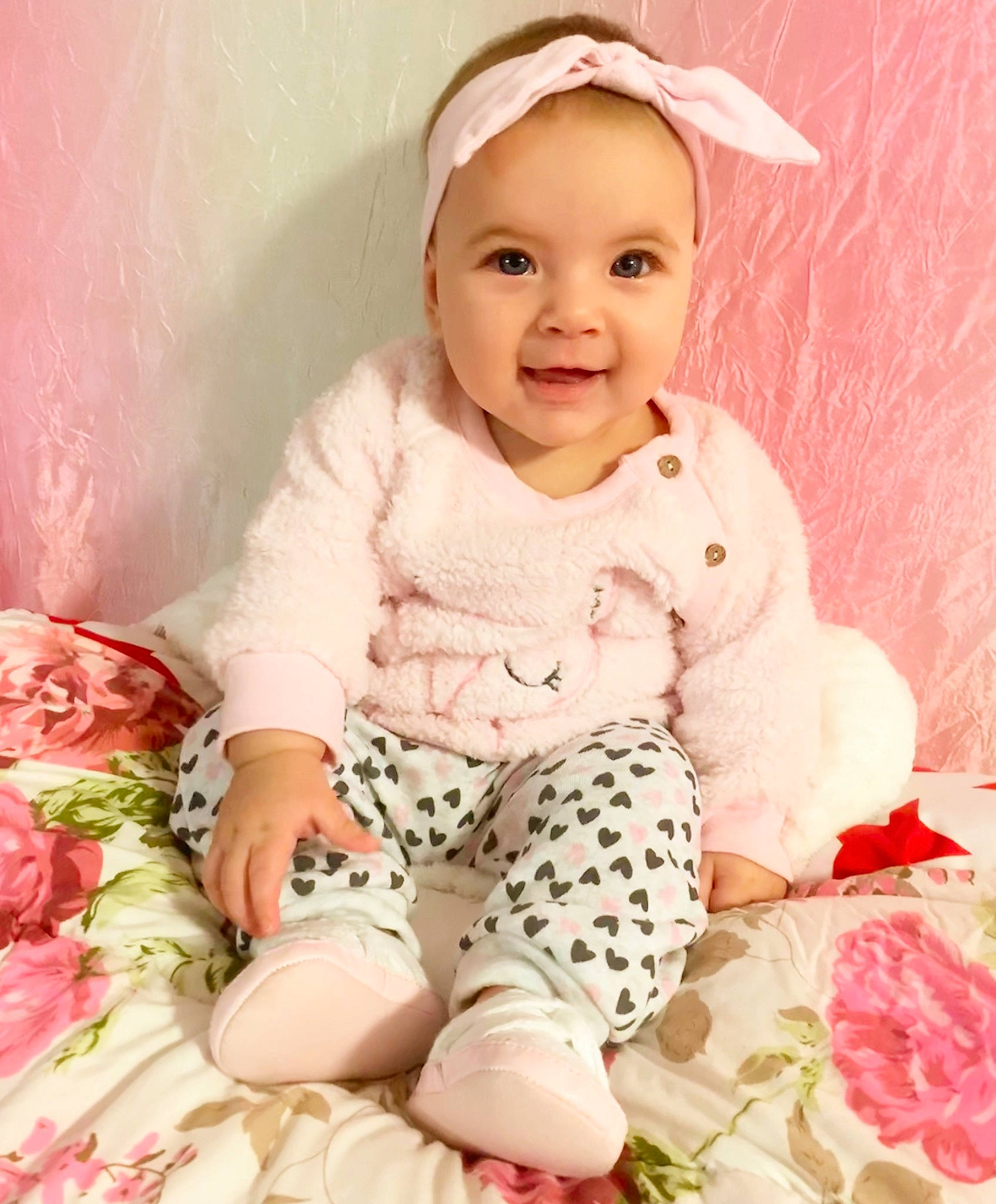 Victoria is registered to the contest to win money with this photo: baby, baby_products, baby_toddler_clothing, cheek, child, child_model, hair_accessory, headband, pattern, peach, person, pink, product, sleeve, smile, textile, toddler