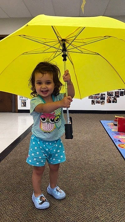 Isabelle joined the competition — help win amazing prizes! child, event, fashion_accessory, flooring, fun, happy, joy, leisure, person, play, product, recreation, sandal, shade, smile, toddler, travel, umbrella, vacation, yellow