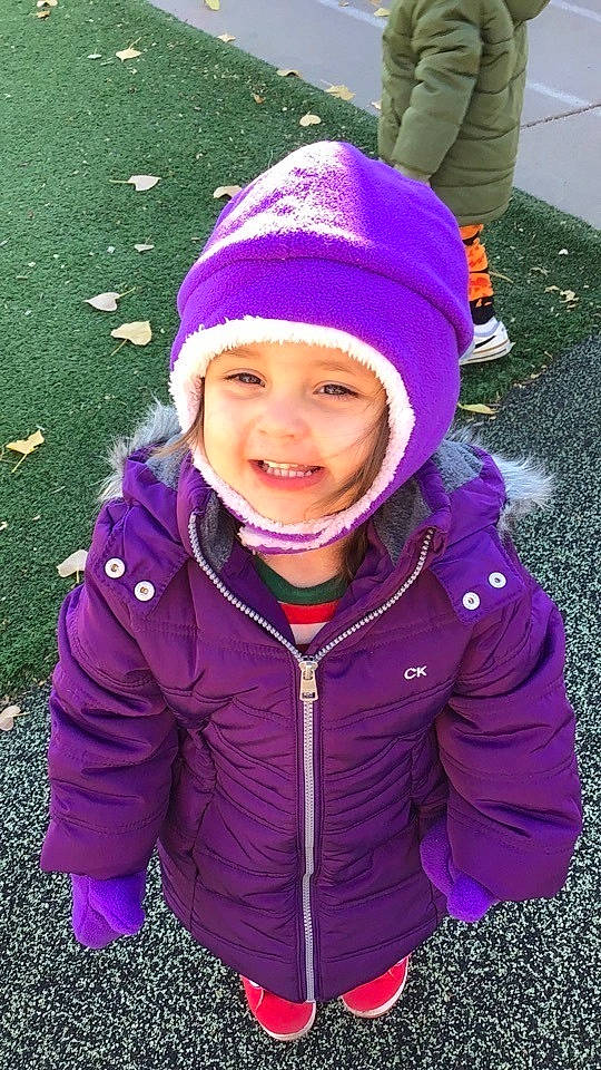 Isabelle is registered to the contest to win money with this photo: cap, cool, electric_blue, fashion_accessory, fun, grass, happy, headwear, jacket, joy, knit_cap, leisure, magenta, outerwear, people_in_nature, person, pink, purple, sleeve, smile