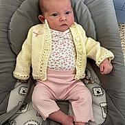 Aoife joined the competition — help win amazing prizes! baby, infant, knitted_cardigan, pink_pants, baby_seat, cushion, animal_print, footwear, clothing, indoor, person, newborn, cute, serious_face, soft_fabric, child, resting, small_feet, comfort, casual