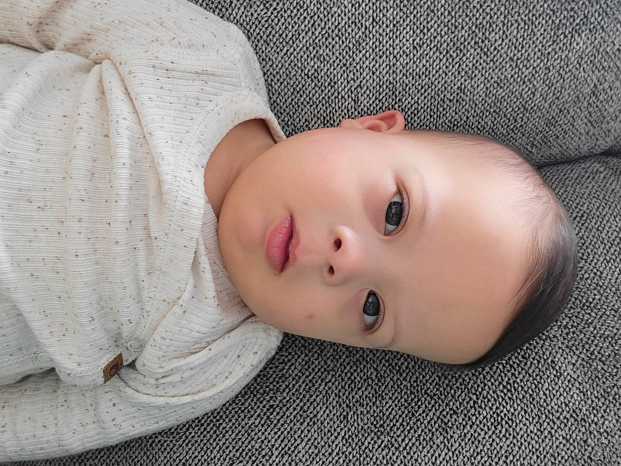 Theodore is registered to the contest to win money with this photo: baby, baby_toddler_clothing, cheek, child, comfort, eye, eyelash, face, fur, iris, lip, nose, pattern, person, portrait_photography, skin, sleeve, toddler, wood, wool