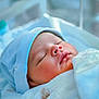 newborn, baby, sleeping, blanket, hat, hospital, bassinet, infant, soft, cozy, face, peaceful, child, closeup, portrait, indoors, healthcare, rest, cute, toddler