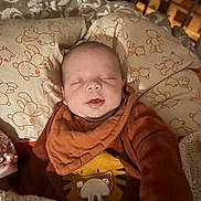 Samaël a rejoint le concours — aidez-le/la à gagner de superbes lots ! baby, sleeping, pillow, blanket, teddy_bear_pattern, cozy, infant, smile, clothing, cute, indoors, child, soft_lighting, tiger_design, knitted_blanket, resting, portrait, peaceful, closeup, warm