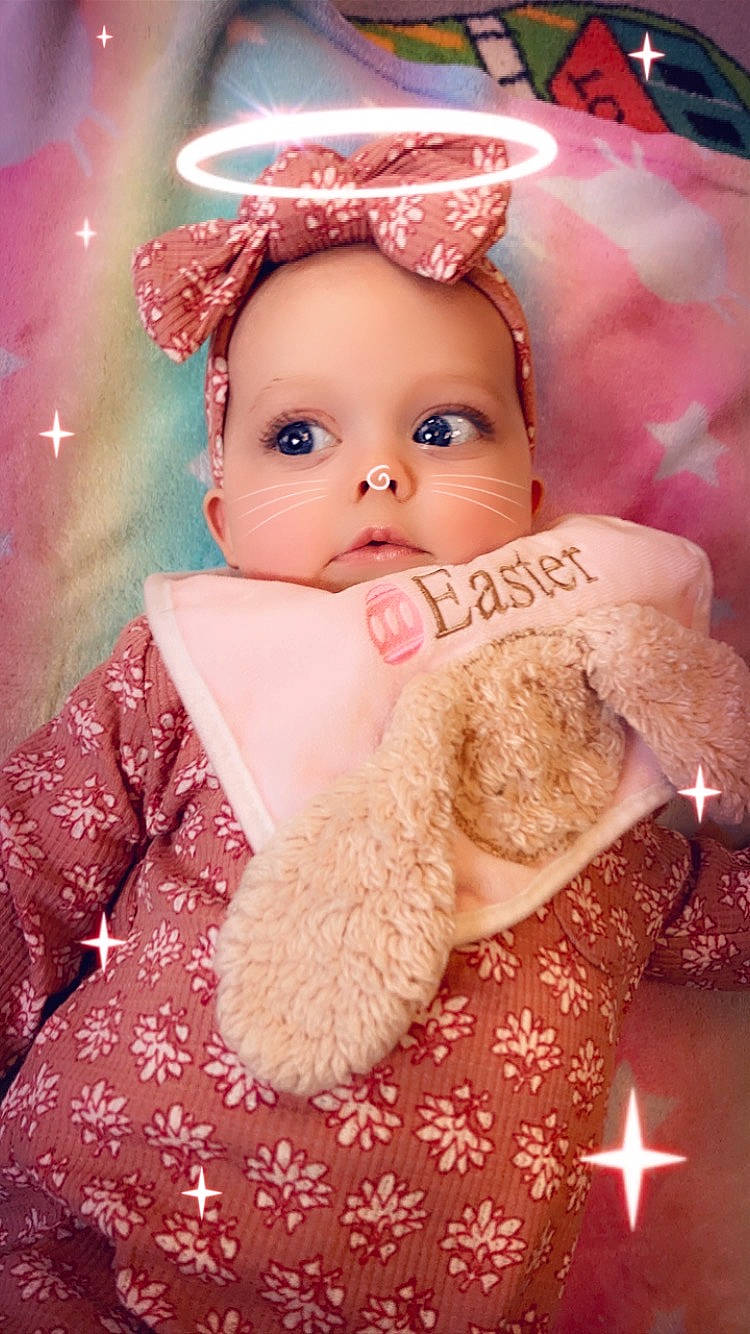 Taegan joined the competition — help win amazing prizes! baby, cap, cheek, child, doll, eye, eyelash, fur, happy, headgear, lip, magenta, outerwear, peach, person, pink, skin, stuffed_toy, textile, toy