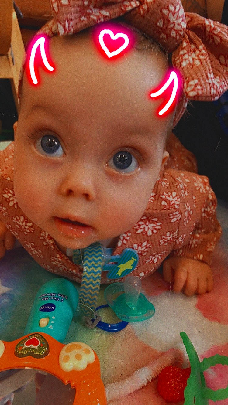 Taegan joined the competition — help win amazing prizes! baby, baby_toddler_clothing, cheek, chin, eye, eyebrow, eyelash, face, forehead, happy, head, iris, lip, mouth, nose, person, pink, red, skin, surprise
