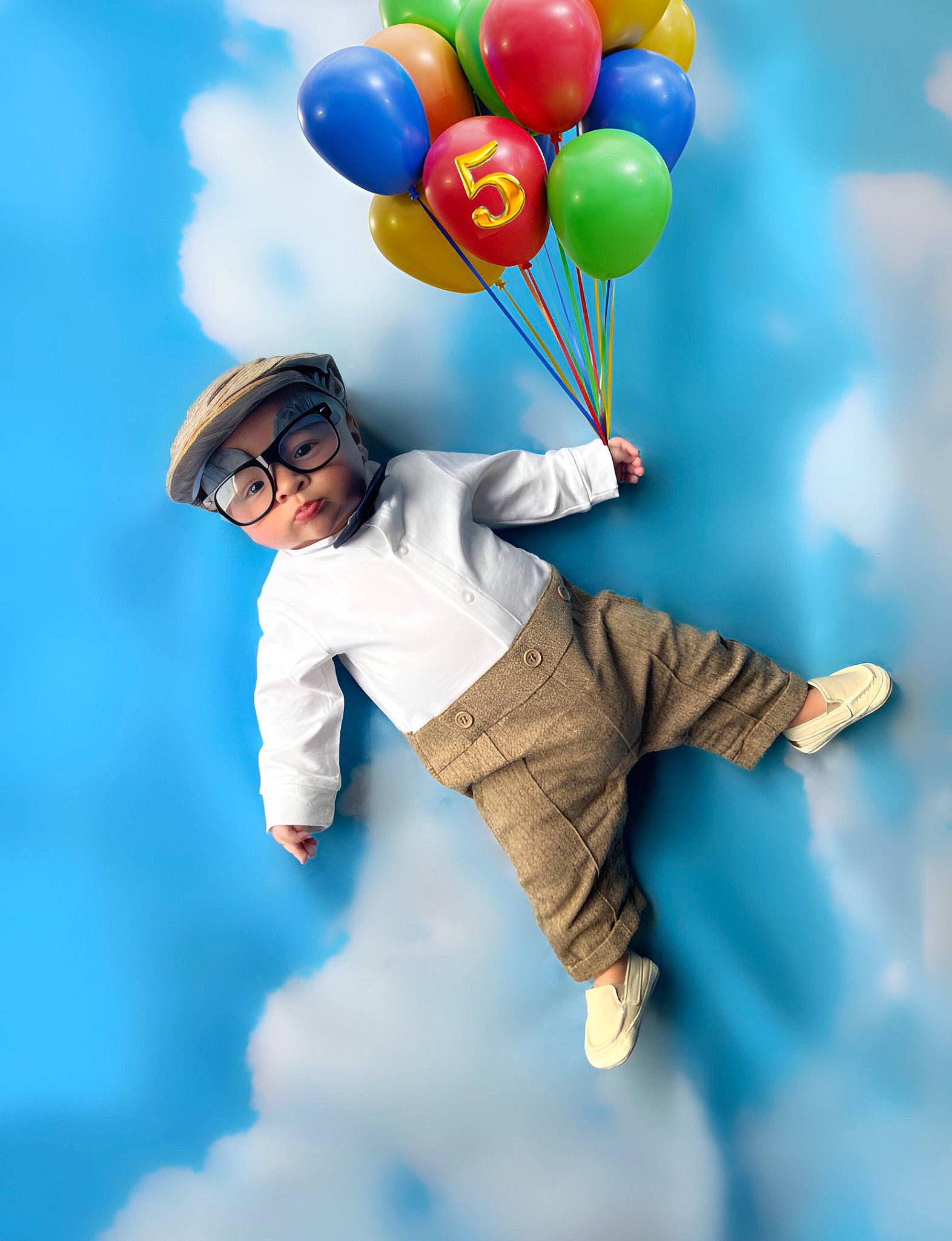 Greyson is registered to the contest to win money with this photo: balloon, blue, child, cloud, electric_blue, event, flash_photography, fun, gesture, happy, headwear, human_body, leisure, nature, party_supply, people_in_nature, person, recreation, sky, stock_photography