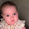 baby, child, face, blue_eyes, drool, curious, floral_outfit, infant, portrait, cute, skin, head, person, young_child, clothing, indoors, expression, closeup, pink_cheeks, baby_girl