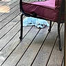 Angel is registered to the contest to win money with this photo: dog, white_dog, wooden_floor, deck, chair, outdoor, pet, relaxing, cushion, metal_frame, furniture, animal, resting, domestic_animal, canine, summer, sunlight, quiet, lazy, home