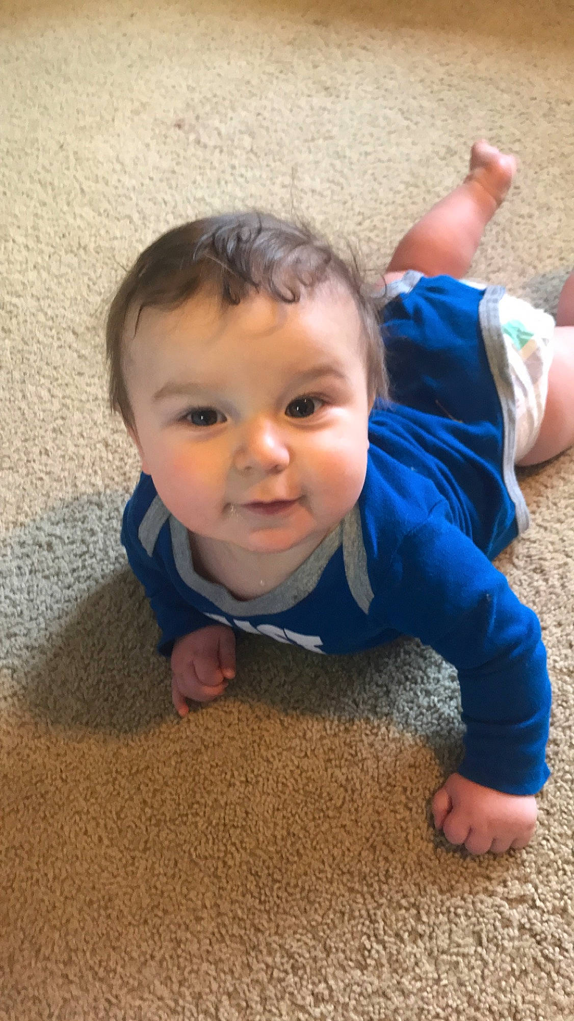 Kylan is registered to the contest to win money with this photo: baby, cheek, child, crawling, face, finger, floor, flooring, fun, head, nose, person, play, sitting, skin, smile, toddler, tummy_time