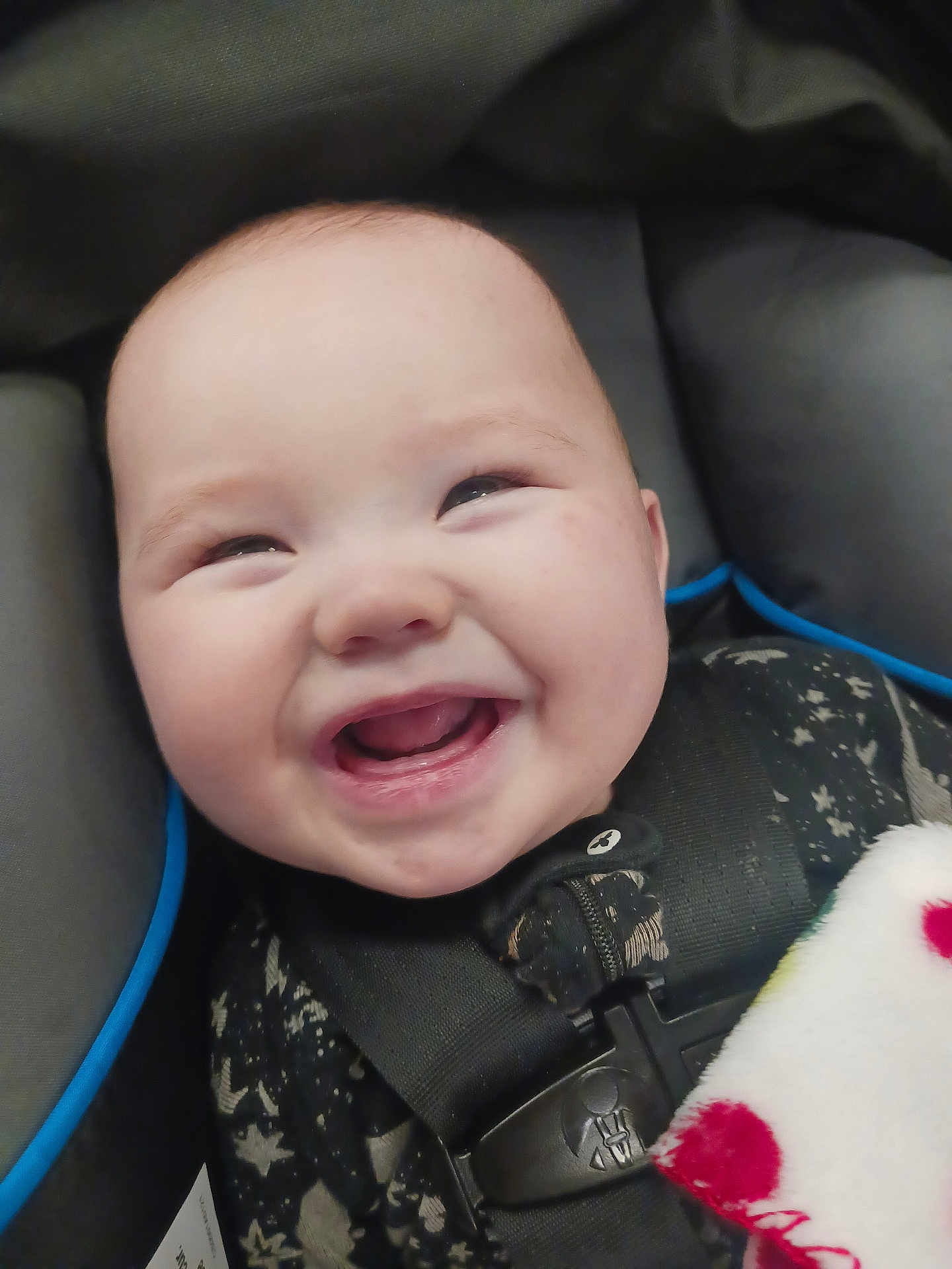 Malachi is registered to the contest to win money with this photo: baby, smiling, car_seat, child, infant, seatbelt, blanket, happy, face, clothing, closeup, cute, safety, portrait, young_child, baby_clothes, indoor, seat, infant_toddler, polka_dot