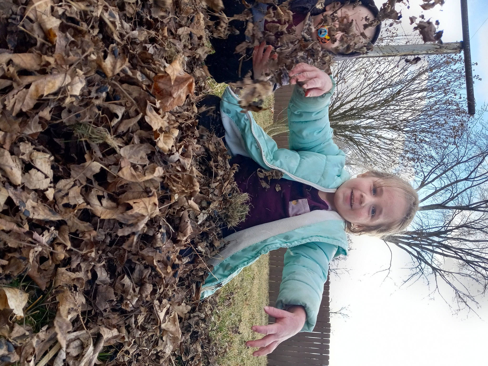 Gracie is registered to the contest to win money with this photo: child, deciduous, fun, grass, happy, leaf, leisure, people_in_nature, person, plant, shrub, sky, smile, soil, tree, trunk, twig, winter, wood, woody_plant