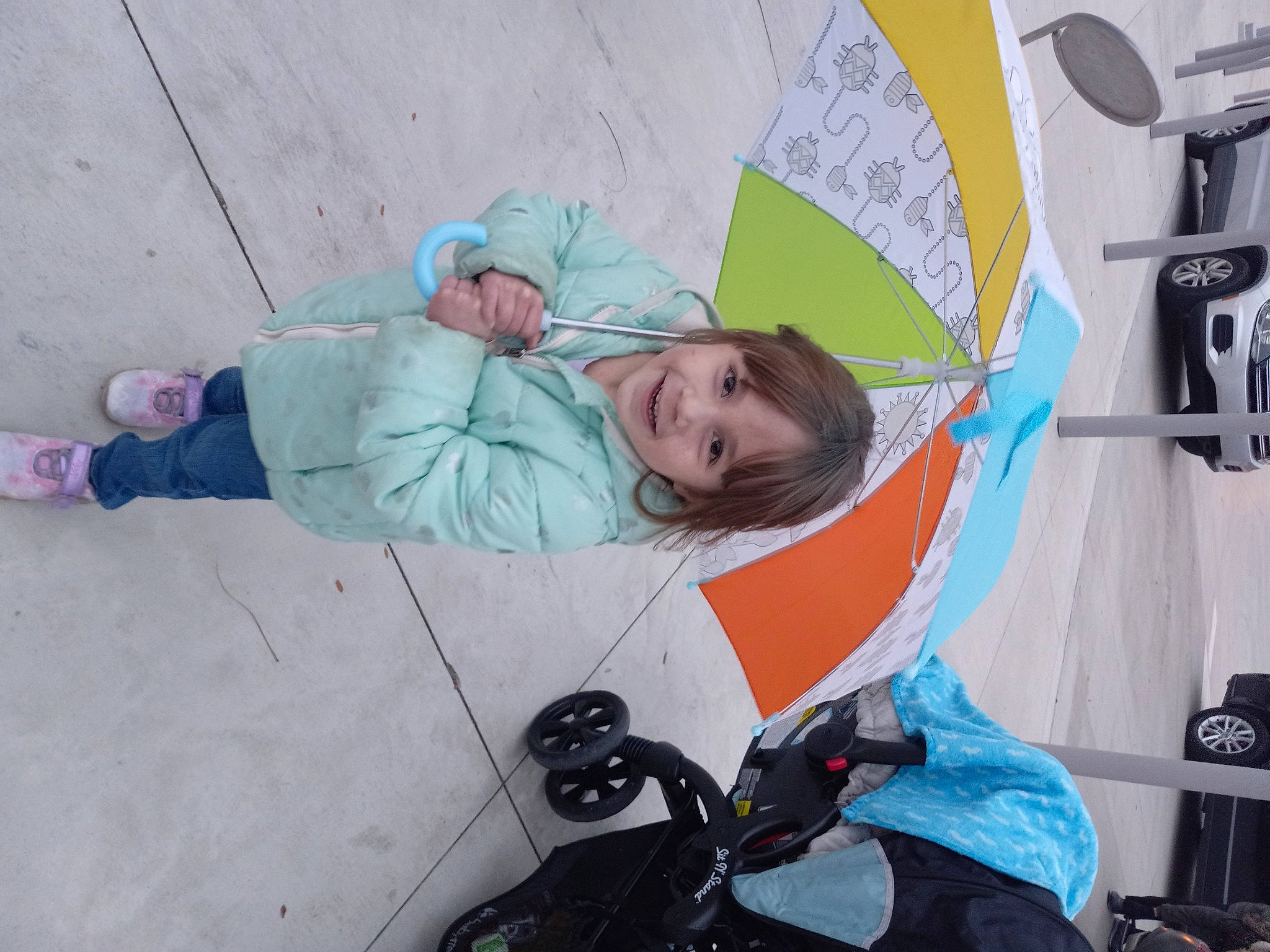 Gracie is registered to the contest to win money with this photo: adventure, auto_part, automotive_design, automotive_window_part, baby_products, child, fun, glove, joy, leisure, motor_vehicle, person, personal_protective_equipment, recreation, sitting, toddler, tree, umbrella, visual_arts