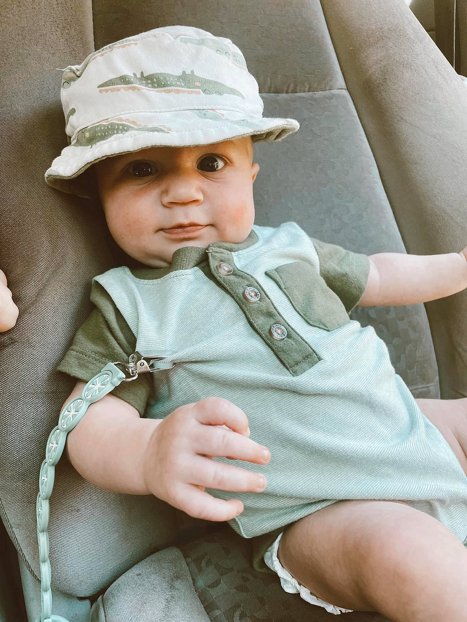 Bentlee is registered to the contest to win money with this photo: baby, baby_products, baby_toddler_clothing, cap, cheek, child, chin, comfort, fashion_accessory, hat, headgear, headwear, lip, person, seat_belt, sitting, skin, sleeve, sun_hat, thigh