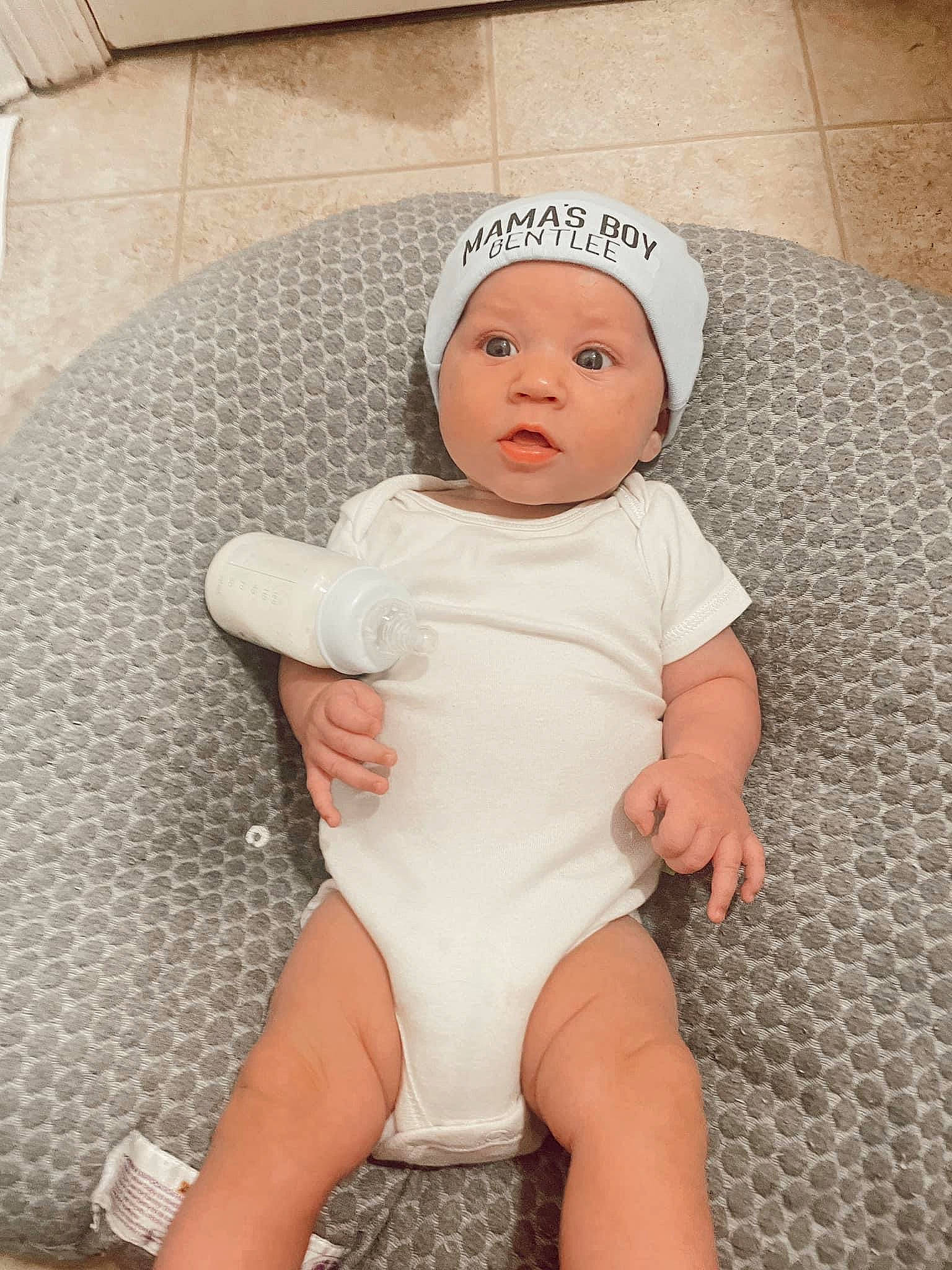 Bentlee joined the competition — help win amazing prizes! baby, baby_products, baby_sleeping, baby_toddler_clothing, cheek, comfort, eye, face, head, headgear, headwear, human_body, human_leg, infant_bodysuit, knee, linens, person, skin, stomach, surprise