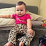 baby, child, infant, sitting, carpet, pink_shirt, leopard_print_pants, barefoot, indoor, pillows, soft_toys, cute, confident, face, hand, foot, home, room, young_child, portrait
