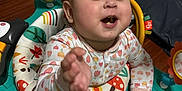 Juliet is registered to the contest to win money with this photo: baby, child, activity_center, toy, smiling, playful, indoor, colorful, clothing, face, hand, floor, happy, infant, person, seat, expression, playtime, cute, toddler
