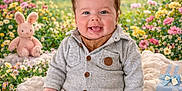 Gaël participe au concours pour gagner de l'argent avec cette photo : baby, smiling, child, blanket, flower, outdoor, garden, plush_toy, bunny, gift_box, bunting, greenery, nature, corduroy_pants, knit_jacket, cute, portrait, sitting, happy, soft_texture