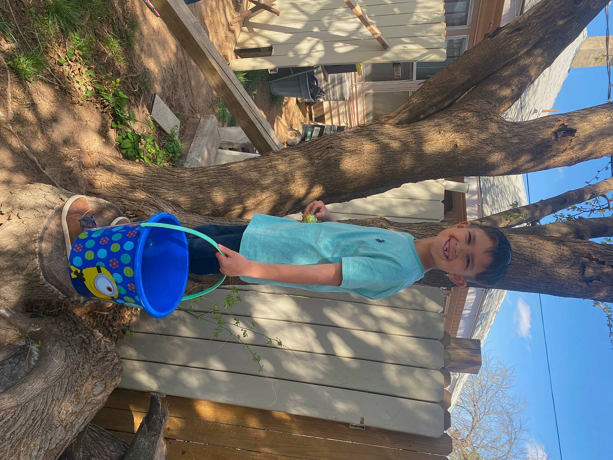 Camdyn is registered to the contest to win money with this photo: branch, electric_blue, fun, grass, human_leg, joy, leaf, leisure, people_in_nature, person, plant, sky, soil, spring, t_shirt, tree, trunk, twig, wall, wood