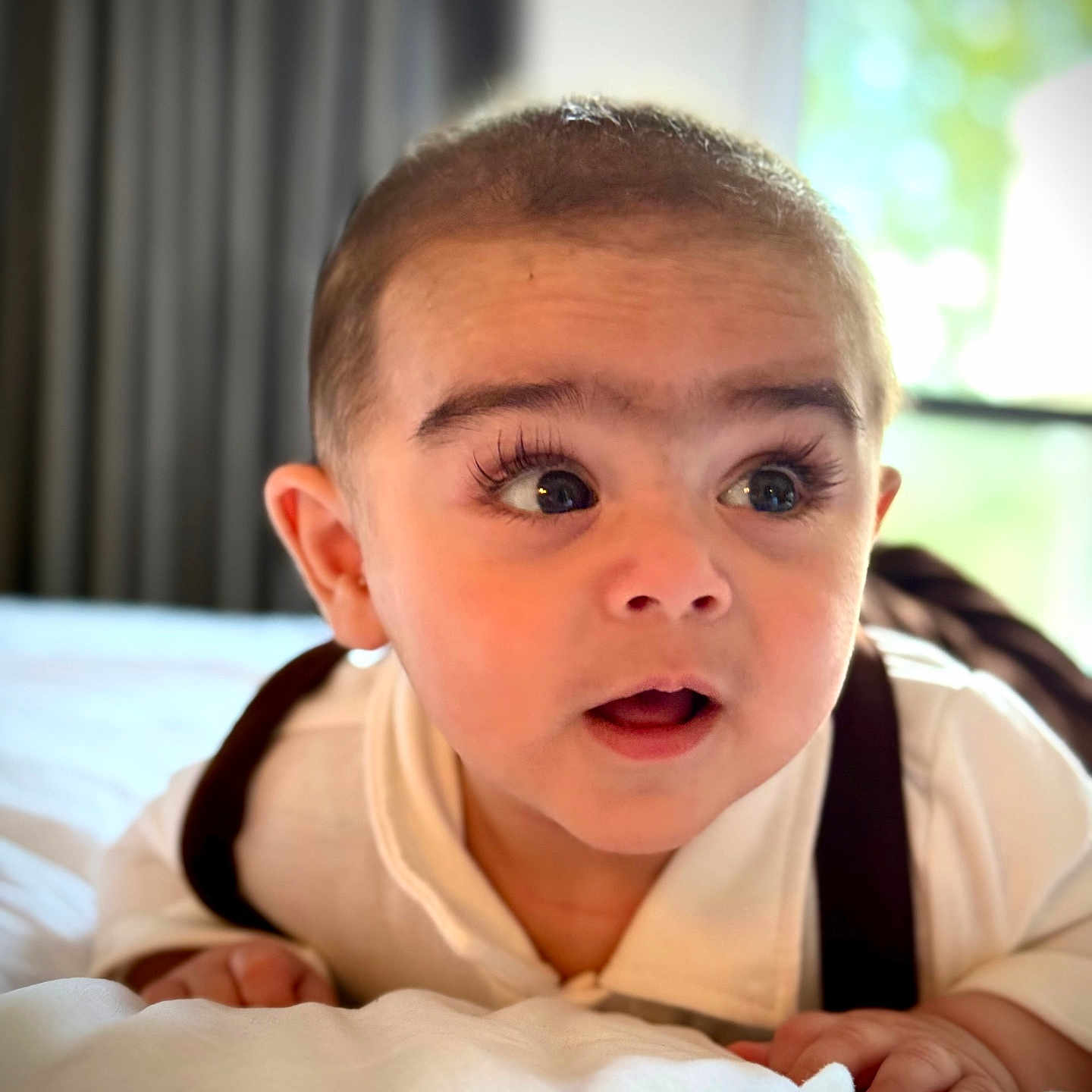 Lemar joined the competition — help win amazing prizes! baby, bed, blanket, child, clothing, curtains, cute, expression, eyes, face, hand, head, indoor, infant, mouth, portrait, skin, suspenders, white_outfit, window