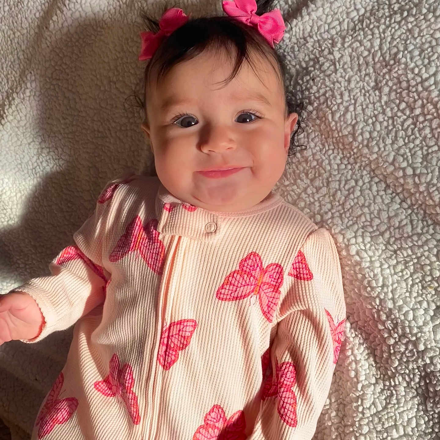 Maríposa joined the competition — help win amazing prizes! baby, babylaughing, blackhair, brownhair, clothing, dimples, dress, face, hair, happy, head, newborn, pajamas, person, photography, portrait, sitting, sleeve, smile