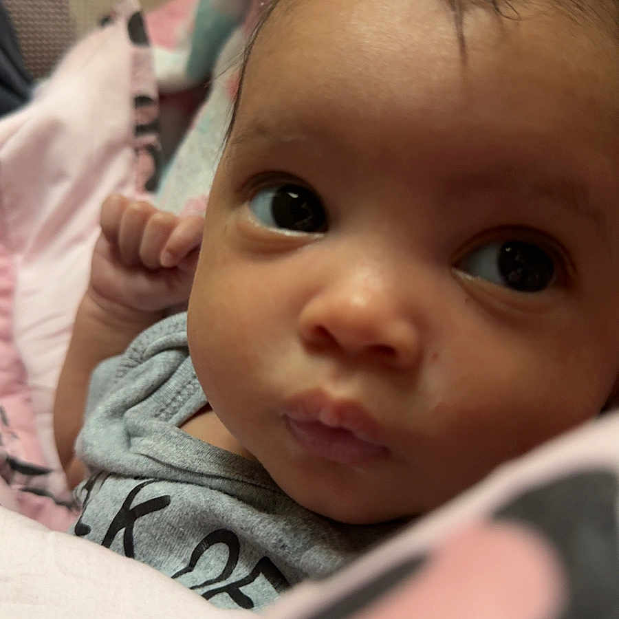 Aurora is registered to the contest to win money with this photo: baby, blanket, close_up, clothing, cozy, curious, cute, expression, eyes, face, hand, head, indoor, infant, newborn, person, portrait, skin, soft, young