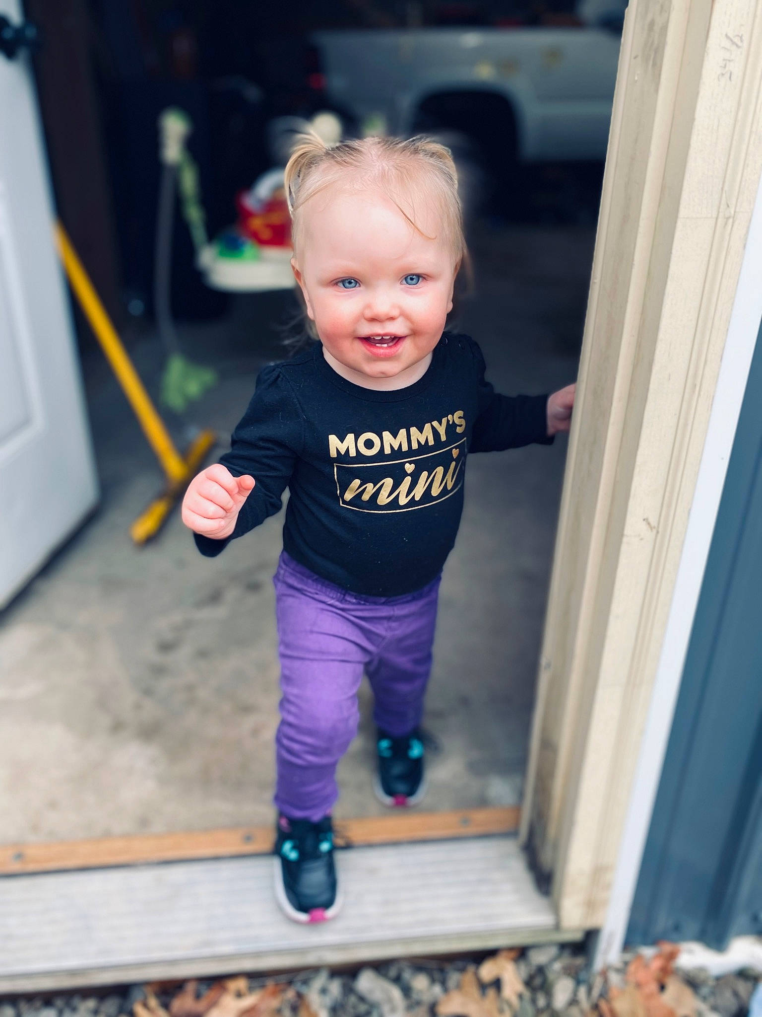 Oaklee is registered to the contest to win money with this photo: baby, baby_toddler_clothing, cheek, door, electric_blue, eye, floor, flooring, fun, happy, head, person, product, purple, sleeve, smile, snapshot, standing, sweatpant, t_shirt