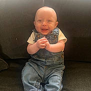 Blake joined the competition — help win amazing prizes! baby, child, smiling, denim_overalls, sitting, couch, happy, infant, clothing, hands, face, portrait, indoor, cute, young, person, feet, footwear, light, texture