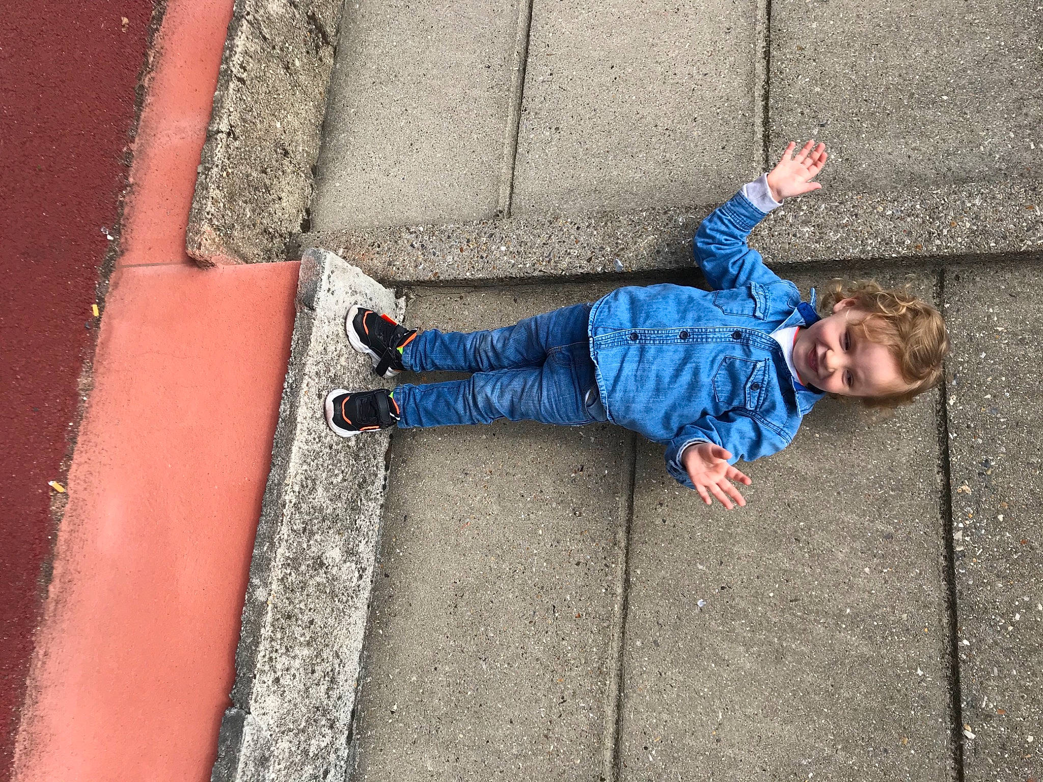 Mohammed participe au concours pour gagner de l'argent avec cette photo : asphalt, blue, child, concrete, jeans, joy, person, road_surface, sidewalk, wall
