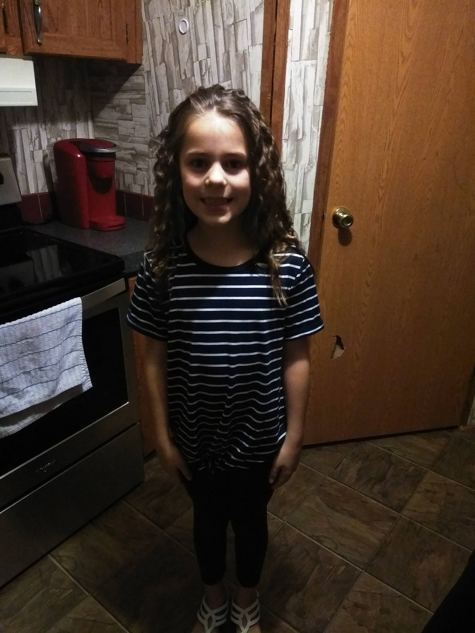 Madison is registered to the contest to win money with this photo: child, eyewear, face, glasses, leg, person, photography, shoe, shoulder, smile, standing, t_shirt, toddler