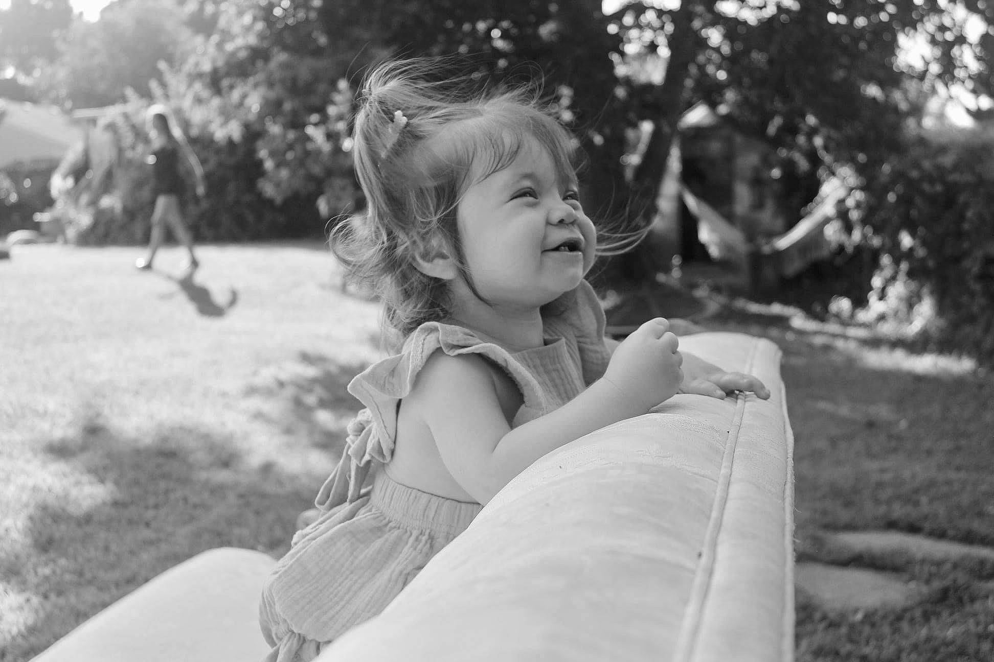 Kyra is registered to the contest to win money with this photo: black_and_white, daytime, facial_expression, flash_photography, grass, hairstyle, happy, human, leaf, lip, mammal, nature, people_in_nature, person, plant, smile, standing, style, sunlight, tree