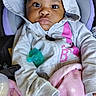 baby, child, hoodie, blanket, car_seat, pacifier, pink, grey, polka_dot, clothing, portrait, infant, cute, indoors, seated, young_child, face, expression, warm, cozy