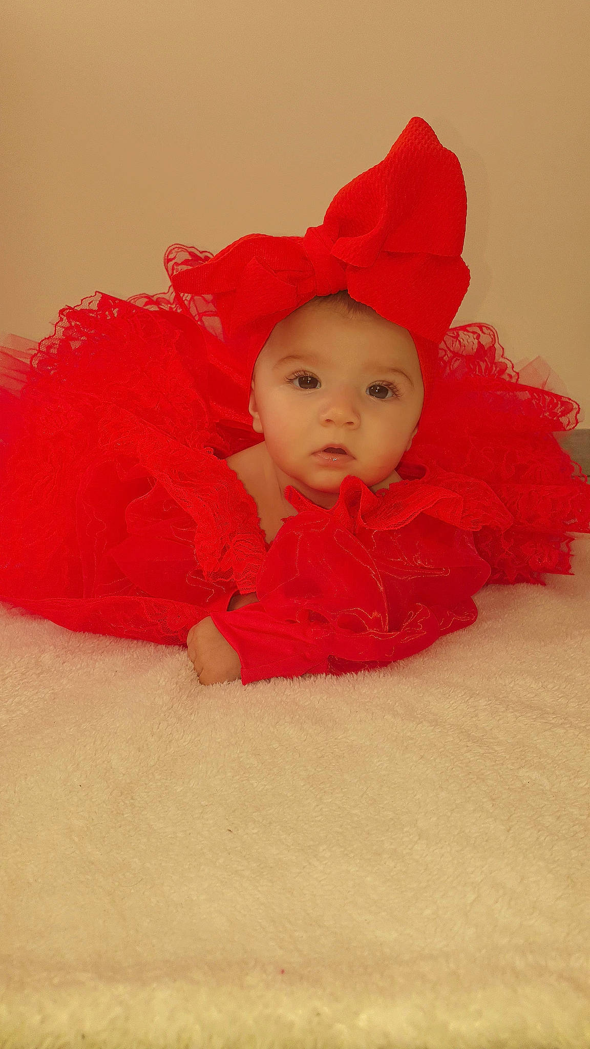 Ayana a rejoint le concours — aidez-le/la à gagner de superbes lots ! baby, baby_toddler_clothing, carmine, child, comfort, costume_hat, flooring, fur, happy, hat, headgear, headwear, linens, lip, magenta, peach, person, petal, sitting, sleeve