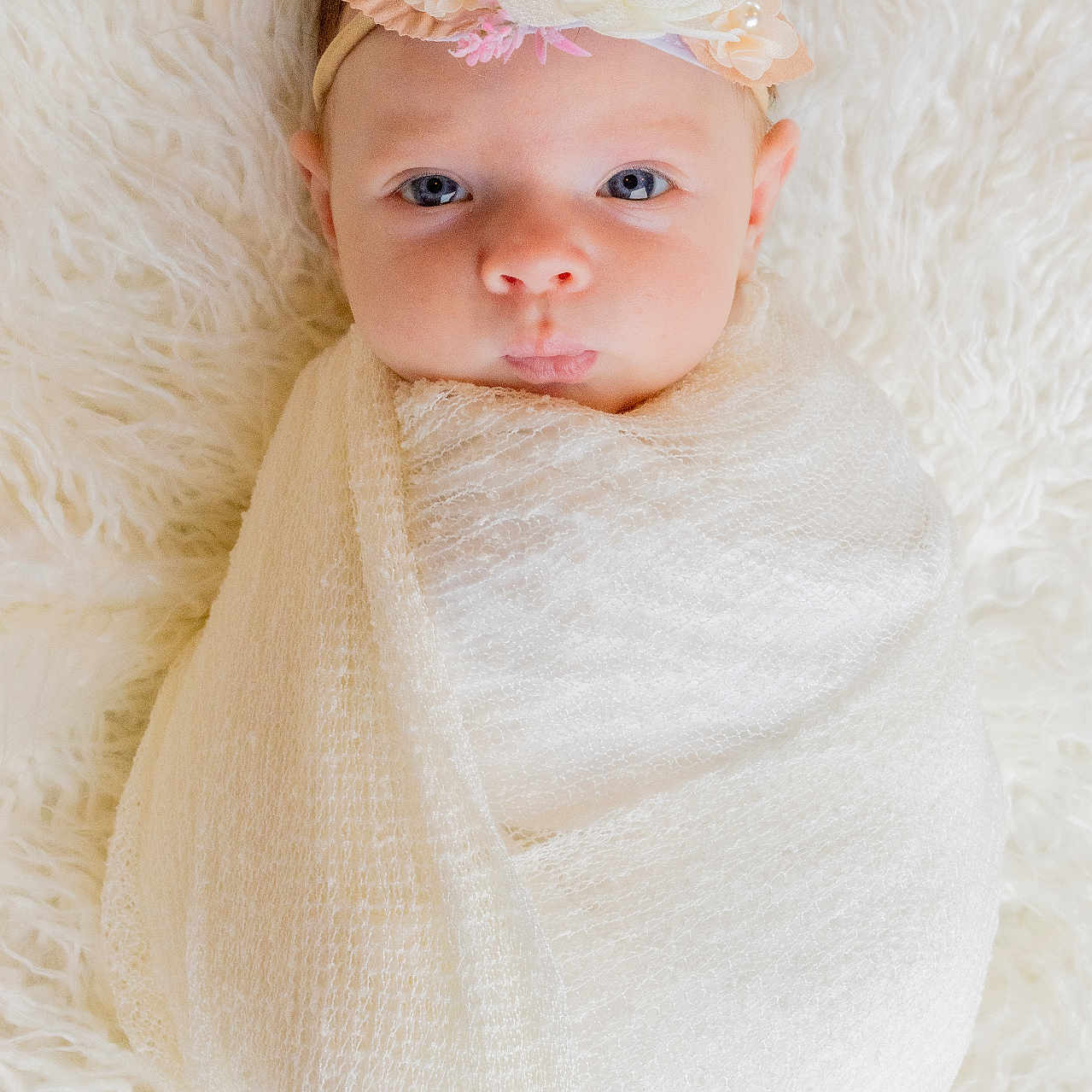 Faelan joined the competition — help win amazing prizes! adorable, baby, blanket, child, closeup, cute, eyes, face, flower, headband, indoors, infant, lying_down, newborn, peaceful, portrait, skin, soft_texture, white, wrapped