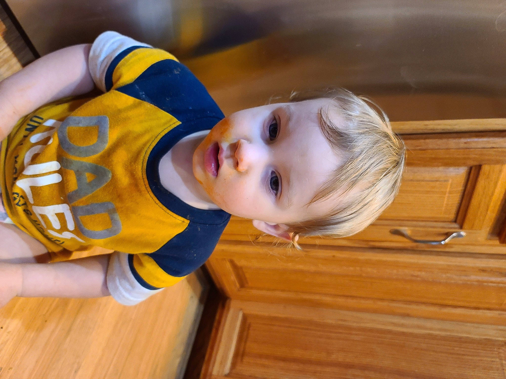 Carl is registered to the contest to win money with this photo: baby_toddler_clothing, child, elbow, flooring, fun, happy, hardwood, hat, knee, leisure, person, room, sleeve, smile, sportswear, t_shirt, toddler, varnish, wood, wood_flooring