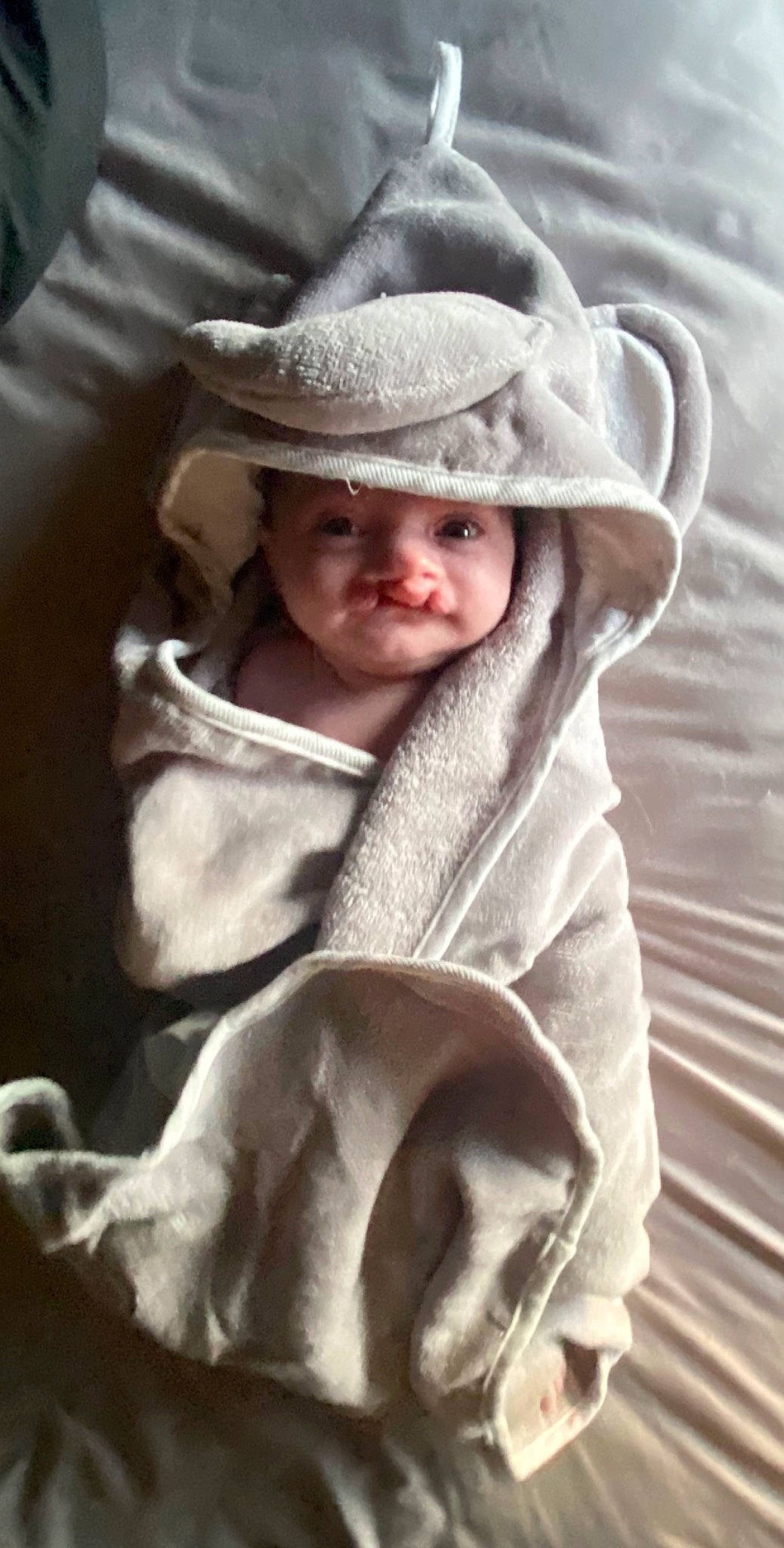 Blair is registered to the contest to win money with this photo: baby, baby_products, cap, child, comfort, eye, fashion_accessory, fur, fur_clothing, happy, hat, headgear, headwear, linens, outerwear, person, sitting, sleeve, smile, sun_hat