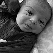 Zacheriah is registered to the contest to win money with this photo: baby, infant, face, portrait, black_and_white, blanket, clothing, newborn, cute, expression, soft, lying_down, texture, closeup, child, person, sleepwear, head, skin, babywear