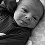 baby, infant, face, portrait, black_and_white, blanket, clothing, newborn, cute, expression, soft, lying_down, texture, closeup, child, person, sleepwear, head, skin, babywear