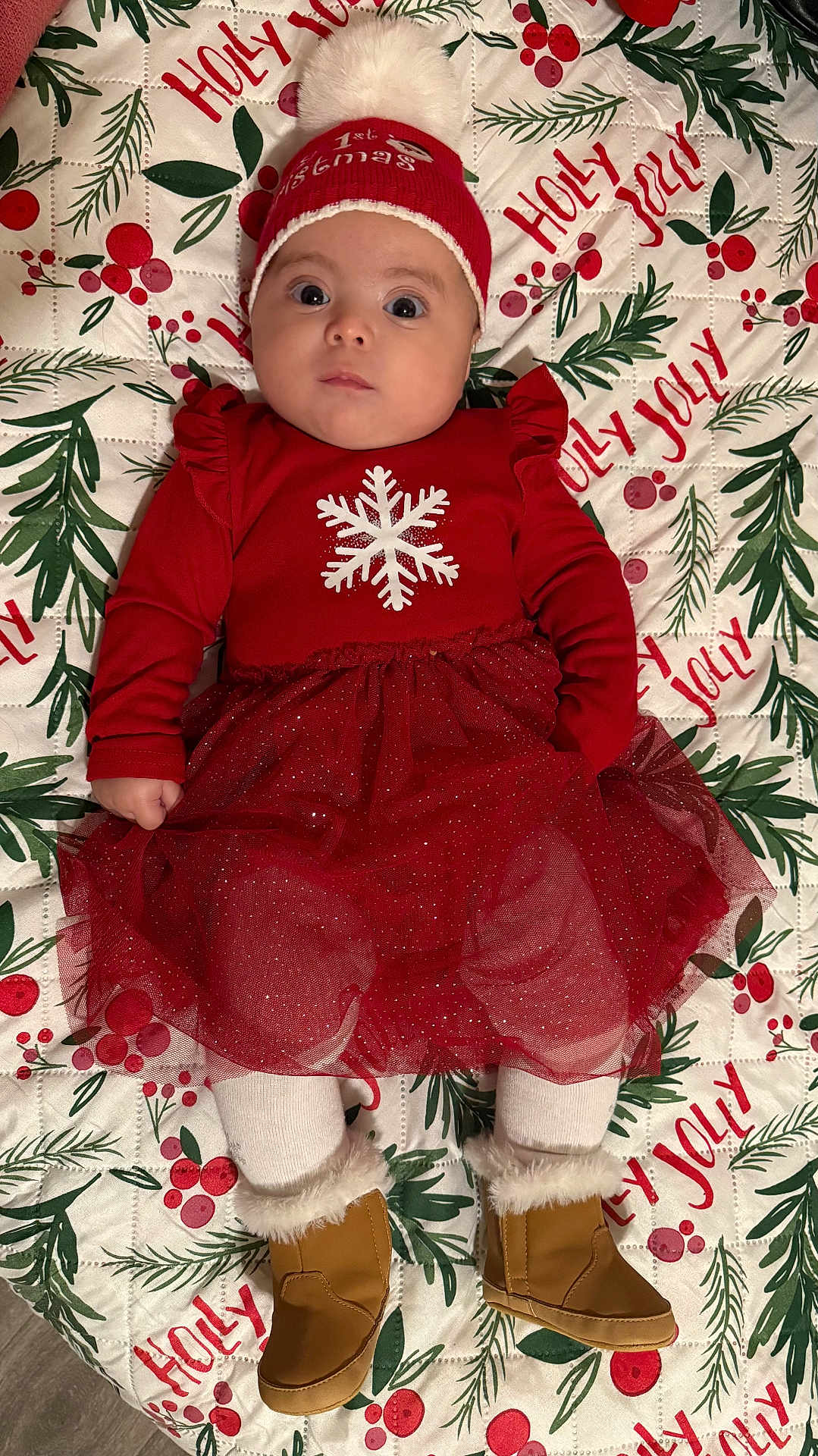 Fergie joined the competition — help win amazing prizes! baby, infant, child, red_dress, christmas_hat, holiday, festive, blanket, holly, berries, greenery, boots, fur_trim, tights, cute, portrait, indoors, lying_down, winter_wear, celebration